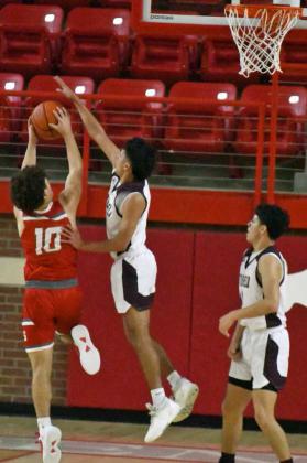 DENYING THE SHOT - Littlefield senior, Elijah Salazar (14), leaps up to deny a shot from Stanton, forcing a jump ball in the first half of the Wildcats, 45-30, victory over the Buffaloes in Denver City on Monday night to claim the 3A Bi-district trophy. (Staff Photo by Derek Lopez)