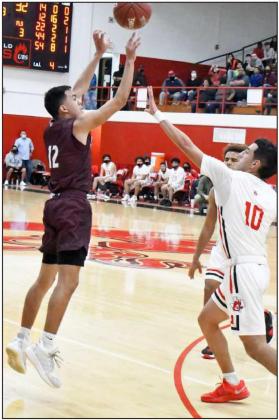 FIRING THE THREE —Littlefield junior, Jordan Trevino (12), puts up a three-point attempt from the right elbow over Jaden Martinez (10), during the Wildcats’ first meeting with the Cubs on the road on Friday at the Pit. (Staff Photo by Derek Lopez)