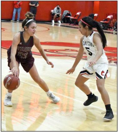 BACKING IT OUT — Littlefield senior guard, Geyah Garza (23), backs the ball out on the right side of the court, as she is being guarded by Lindsey Herrera (5), during the Lady Cats’ first meeting with the Lady Cubs on the road on Friday at the Pit. (Staff Photo by Derek Lopez)