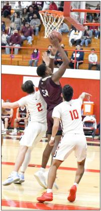 TAKING THE CONTACT—Littlefield senior forward, Tyree Jones (54), puts up a tough layup between two Brownfield defenders, during the second half of the Wildcats’ victory over the Cubs in their first meeting on the road on Friday at the Pit. (Staff Photo by Derek Lopez)