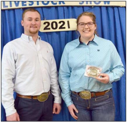 LAMB SHOWMANSHIP AWARD-Madison Young of Olton holds her belt buckle award, as Show Judge, Kinder Harlow admires award. (Staff Photo by Joella Lovvorn)