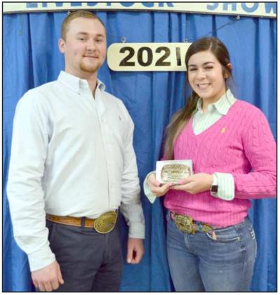 SWINE SHOWMANSHIP-Landree Gonzales, Sudan, holds her award buckle, with the show judge, Kinder Harlow, beside her. (Staff Photo by Joella Lovvorn)