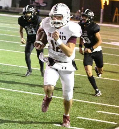 Littlefield senior quarterback, Chip Green, sprints down the Wildcat sideline for a 66-yard touchdown run to open the second half of Littlefield’s, 55-51, loss to the Mules on Friday in Muleshoe. (Staff Photo by Derek Lopez)