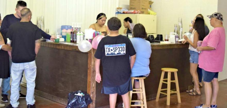 GRAND OPENING -- Kristal Cervantes serves customers during the Grand Opening of K's Nutrition on Saturday, Sept. 4th. They are located at 701 W. 3rd St. (Photo by Ann Reagan)