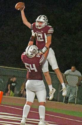 CELEBRATING THE SCORE – Littlefield guard, Brenden Bowman (54), lifts up quarterback, Chip Green (12), after a 21-yard touchdown run, as the Wildcats defeated the Mules, 28-7, on Friday in their 2022 home-opener at Wildcat Stadium in Littlefield. (Staff Photo by Derek Lopez)