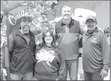 WINNER -- Left to Right- Jason Hesner, Christy De La Cruz, Derek Blair, and JJ Gurerro of Valley Ag Irrigation presented the raffle prize to Jason Hesner the lucky winner in the raffle for a rifle donated by Blair Ag Insurance and presented by Derek Blair. (Photo by Ann Reagan)