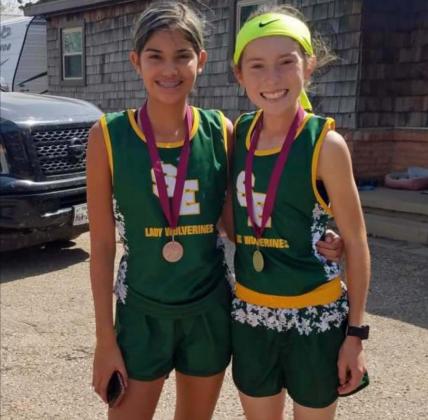 LEADING THE WAY – The Springlake-Earth Lady Wolverines’ varsity cross country team placed second overall at the Abernathy Meet on Saturday. Freshman, DeDe Delgado (Left) placed sixth overall and freshman, Taytum Goodman (Right) finished first overall at the meet. (Submitted Photo)