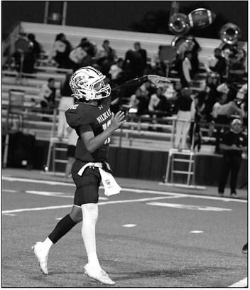 Littlefield’s Sammy Saenz (12) throws a touchdown pass to Jayden Barrio, during the second quarter of the Wildcats’ victory over Muleshoe last Friday. (Staff Photo by Derek Lopez)