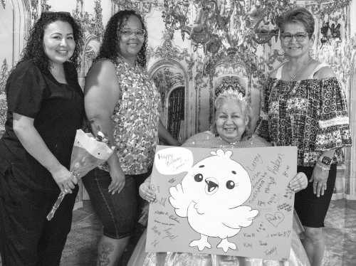 Gracie Rodriguez, Nina Barrios and Amber Washington present Carmen Valdez with a birthday card signed by family and loved ones at her quinceañera on June 25, 2026.