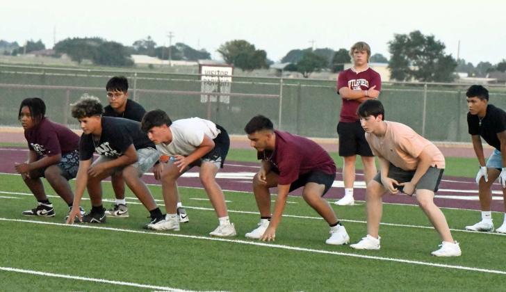 The offensive line gets set to run a play, during Park Practice on Monday at Wildcat Stadium. (Staff Photo by Derek Lopez)