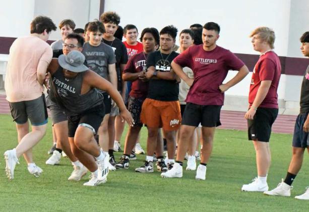 Littlefield’s Marcquis Rosemond demonstrates how to fire off the line into a block, during the first day of Park Practice on Monday at Wildcat Stadium. (Staff Photo by Derek Lopez)