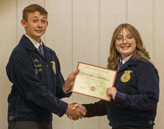 FFA Vice President Ty Carr presents Taylor Campbell with a Greenhand FFA Degree at the annual FFA banquet on May 12, 2025. (Staff Photo by Madison Vidales)