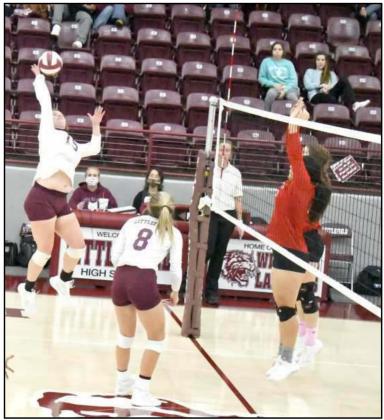 LOOKING FOR A POINT – Littlefield junior, Ashtyn Parker, delivers a kill past the block attempt by Friona, during the first set of their, 3-2, victory on Wednesday at Wildcat Gym in Littlefield. (Staff Photo by Derek Lopez)