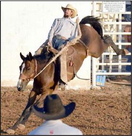 The first Bronc Rider bounces out the gate as this cowboy tries to rack up points to qualify for the National Finals in Amarillo at the WCRA rodeo in Earth, Tx.