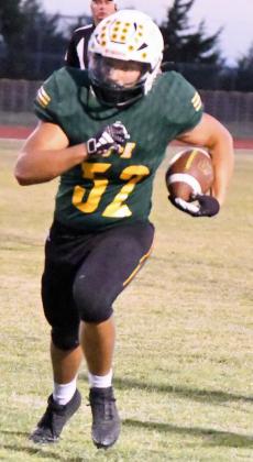 Springlake-Earth’s Tyler Tanaro, takes a carry around the left side, trucking a defender on his way to a solid gain, during the Wolverine’s, 52-6, victory over the Longhorns on Thursday night. (Staff Photo by Derek Lopez)
