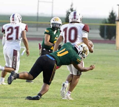 Springlake-Earth’s Donovan Stiggers, makes a tackle near the Wolverine sideline, during the Wolverine’s, 52-6, victory over the Longhorns on Thursday night. (Staff Photo by Derek Lopez)