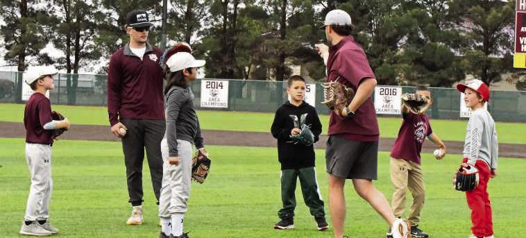 Coach Blake Green goes over insructions for a drill, during the first day of the Wildcat Youth Baseball Camp last Wednesday. (Staff Photo by Derek Lopez)