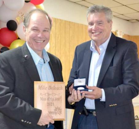 “MAN OF THE YEAR” Award plaque was presented to Lamb County Judge Mike DeLoach, and John Roley presented him with a silver coin. (Staff Photo by Joella Lovvorn)