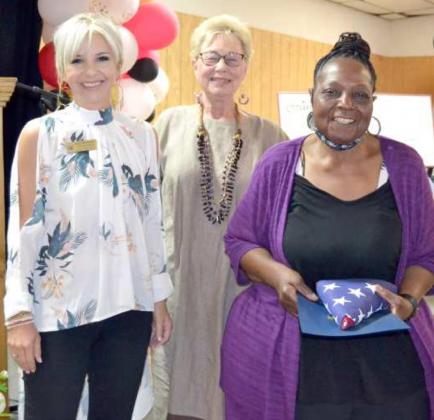 FLAG TO BONNIE ANDERSON --Kaci Morris, rep for Congressman Jodey Arrington, left, presented a US flag to Bonnie Anderson, in reognition of band successes. Jeni D Brunson introduced her.