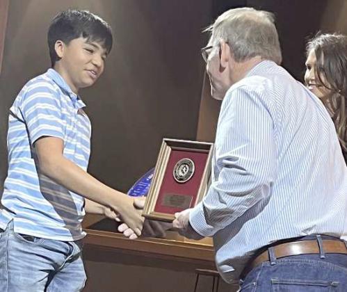 Sudan’s Christian Delgado was recognized at the Area I Conservation Banquet for placing first in District and second in Area in the Junior Essay Category. Shown is Roy Thompson presenting Delgado with his award. (Submitted Photo)