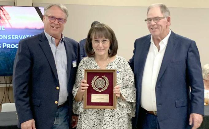 Tretha Caddell wasrecognized by Lamb County for being named District, Area and State Winner of this year’s Conservation Rancher award. She is shown with Scott Buckles (left), who is the Vice-Chairman of the Texas State Soil &amp;amp; Water Conservation Board and Roy Thompson (right), who is the chairman of the Lamb County Soil and Water Conservation District Board. (Submitted Photo)