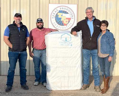 FIRST BALES FOR TEXAS PRODUCERS COOP—Eric and Donna Vaughan, right of cotton bale, brought in the first bale of 2024 cotton to the Texas Producers Cooperative’s Gin. The first bale was ginned on Wednesday, October 9, 2024. It weighed 503 pounds with a 29% turnout and a loan value of $0.5510. Texas Producers Coop CEO, Justin Bellar, and Gin Manager, Duncan Welch, on the left. (Submitted Photo)