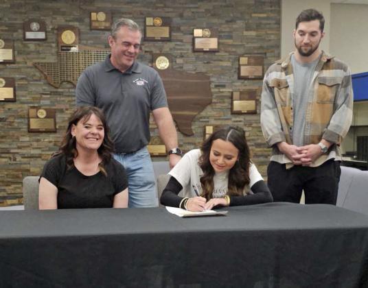 Sudan senior, Journey Baker signed her letter of intent to continue her Cheer and Academic career at Missouri Valley College last Tuesday, during a small signing ceremony in the Sudan High School Library, where she was surrounded by family and friends. (Staff Photo by Derek Lopez)