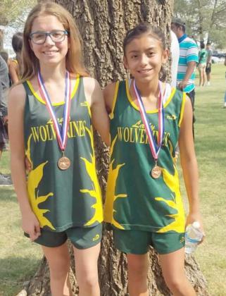 COMPETING – Springlake-Earth Junior High Cross Country runners competed at Plainview this past weekend. Reagan Ethridge (left) finished 11 th , while Arabella Villava finished 10 th overall. (Submitted Photo)