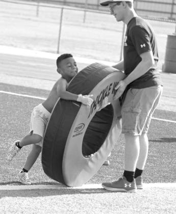 Campers worked on tackling, during the second day of the Littlefield Youth Football Camp at Wildcat Stadium on Tuesday. (Staff Photo by Derek Lopez)