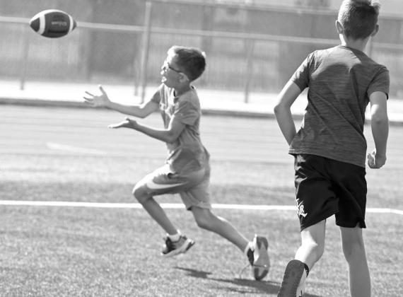 A camper makes a catch, during 1v1 drills on the second day of the Littlefield Youth Football Camp at Wildcat Stadium on Tuesday. (Staff Photo by Derek Lopez)