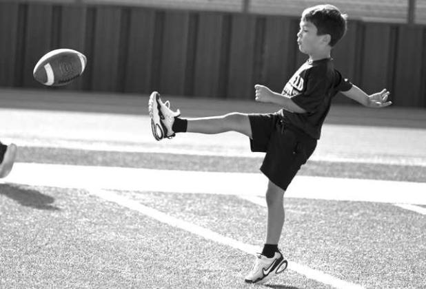 Campers learned how to punt, during the second day of the Littlefield Youth Football Camp at Wildcat Stadium on Tuesday. (Staff Photo by Derek Lopez)