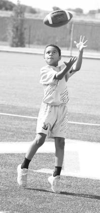 A camper makes a catch, during 1v1 drills on the second day of the Littlefield Youth Football Camp at Wildcat Stadium on Tuesday. (Staff Photo by Derek Lopez)