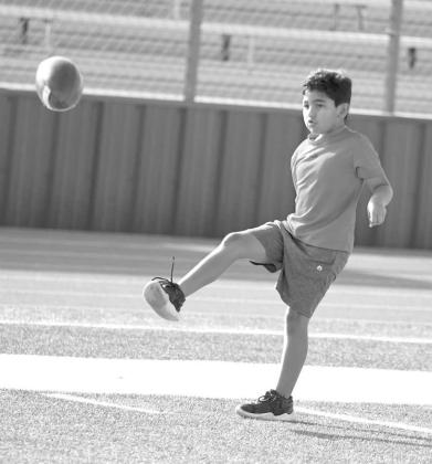 Campers learned how to punt, during the second day of the Littlefield Youth Football Camp at Wildcat Stadium on Tuesday. (Staff Photo by Derek Lopez)
