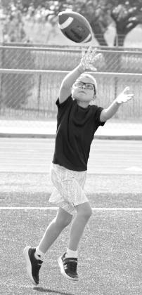 A camper makes a catch, during 1v1 drills on the second day of the Littlefield Youth Football Camp at Wildcat Stadium on Tuesday. (Staff Photo by Derek Lopez)