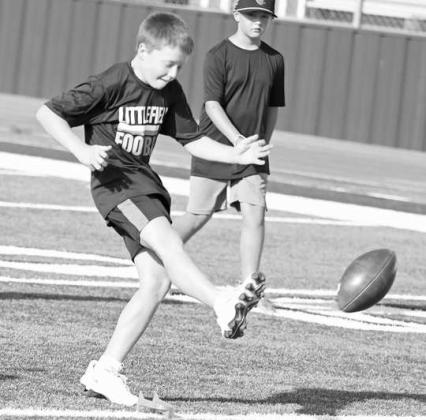 Campers learned how to kick off of a tee, during the second day of the Littlefield Youth Football Camp at Wildcat Stadium on Tuesday. (Staff Photo by Derek Lopez)