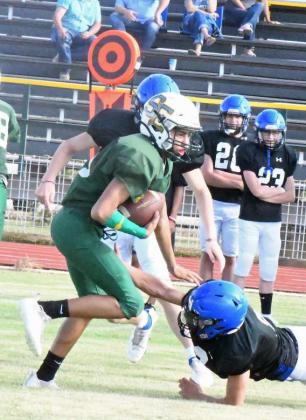 EXTRA YARDS- Springlake-Earth’s Gavin Gonzales stiff arms a Wildorado defender on his way to a nice gain during their scrimmage on Thursday . (Staff Photo by Derek Lopez)