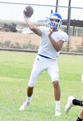 HTTING HIS MAN- Amherst’s quarterback turns and fires a pass to his right during practice on Tuesday.(Staff Photo by Derek Lopez)