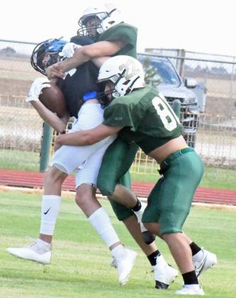WREAKING HAVOC - Springlake-Earth’s Derick Rosalez and Roel Fuentes take down the Wildorado ball carrier in the backfield for a big loss during their first deffensive stand in their scrimmage on Thursday against Wildorado. (Staff Photo by Derek Lopez)