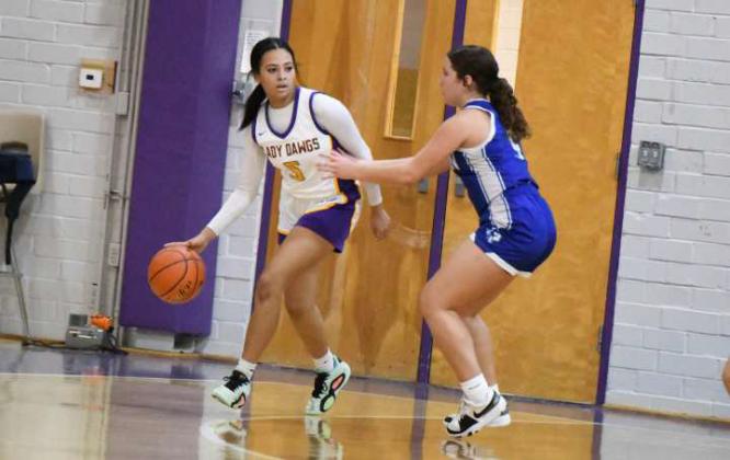Anton freshman, Naliyah Cooper, dribbles around the perimeter, as she’s guarded by Olton’s Kambri Ruiz, during their non-distirct match-up last Saturday in Anton. (Staff Photo by Derek Lopez)
