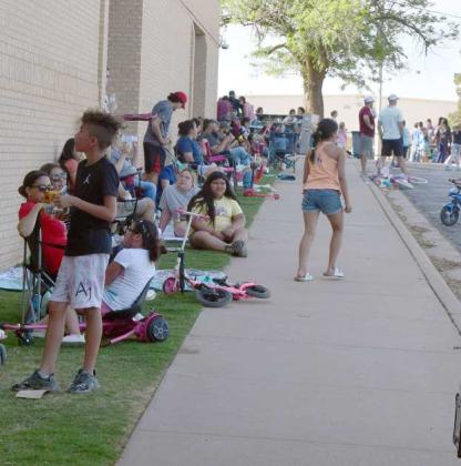Parents of Littlefield Primary enjoyed the shade of the Primary building while watching their children play during the Books, Bikes and Burgers event on May, 5, 2023. (Photo by Ann Reagan)