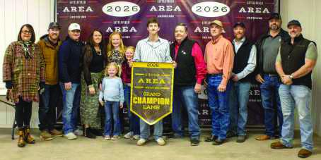Grand Champion Lamb winner Kooper Edwards poses with buyers from First United Bank, Lance Insurance, WDG Trucking, Boehning Dairy, Lamb County Farm Bureau, Sawyer Construction, Lamb County Electric, Texas Producers Co-Op, Lowe's, Jerry and Cheryl Sowder, Hereford Grain, and Seth and Megan Sowder.