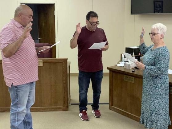 CITY COUNCIL members were given Oaths of Office during a special meeting at 12 noon Thursday, May 12, 2022. The canvass of the May 7, 2022 General Election, and a resolution declaring the result of that election to fill a two-year term in District 1 for Eric Saenz, (left), were approved. City Secretary Janine Butler is shown administering the Oaths of Office for Saenz and Rangel after they signed the Secretary of State Form 2201. The meeting adjourned at 12:04 p.m. (Mayor Eric Turpen photo)