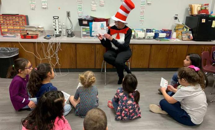 THE “CAT IN THE HAT” was reading a story and showing a picture to Primary students during their special reading program Monday evening, Feb. 28, 2022. (Submitted Photo)