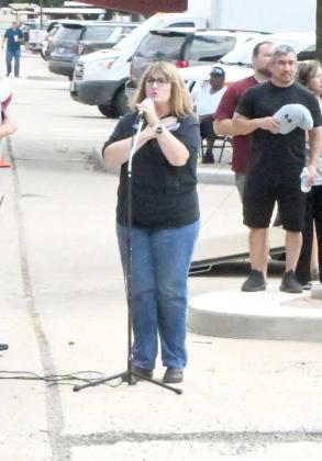 Kyla Howell sings the National Anthem at the 2023 Wildcat Street Party Friday morning, which took place on Phelps Ave. (Staff Photo by Derek Lopez)