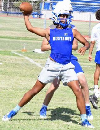 Shown is quarterback, Raymond Ramirez working on his timing with the receivers, during the Olton Mustangs second day of two-a-days on Tuesday. (Staff Photo by Derek Lopez)