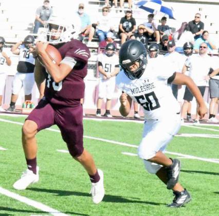 BREAKING LOOSE - Littlefield JV quarterback, Nate Castaneda (10), breaks loose for a huge gain, during the first half of the Wildcats’ victory over the Mules in their season-opener last Thursday. (Staff Photo by Derek Lopez)