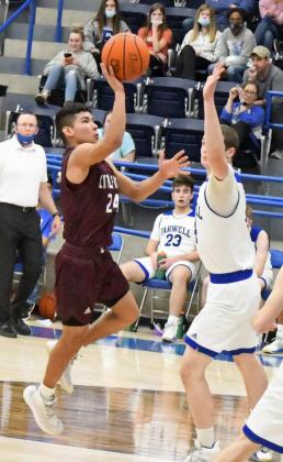 GETTING TO THE PAINT—Littlefield senior, Joseph Salinas, gets into the interior of the defense and puts up a floater over the Steers defense, during the fust half of the Wildcats’ road loss to Farwell on Tuesday. (Staff Photo by Derek Lopez)