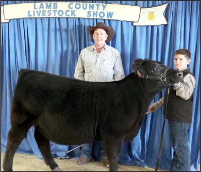 Hudson DeBerry of Olton and his Heifer earned Reserve Grand Champion at the Lamb County Junior Livestock Show that took place in Littlefield on Saturday. (Photo by Ann Reagan)