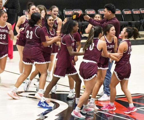 The Littlefield Lady Cats celebrate at halfcourt after a senior, Cali Saldana nails a halfcourt buzzer beater with just over .5 seconds remaining in the game to lift the Lady Cats past the Tigerettes, 51-50, in Slaton. They improve to 2-1 in district play. (Staff Photo by Derek Lopez)