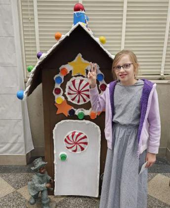 Rebekah Tucheck was the first place winner in the 9-12-year old division of the Lamb County Library’s Gingerbread House Contest. The winners were announced after the Lighted Christmas Parade on Friday at the Library’s Open House. (Staff Photo by Derek Lopez)